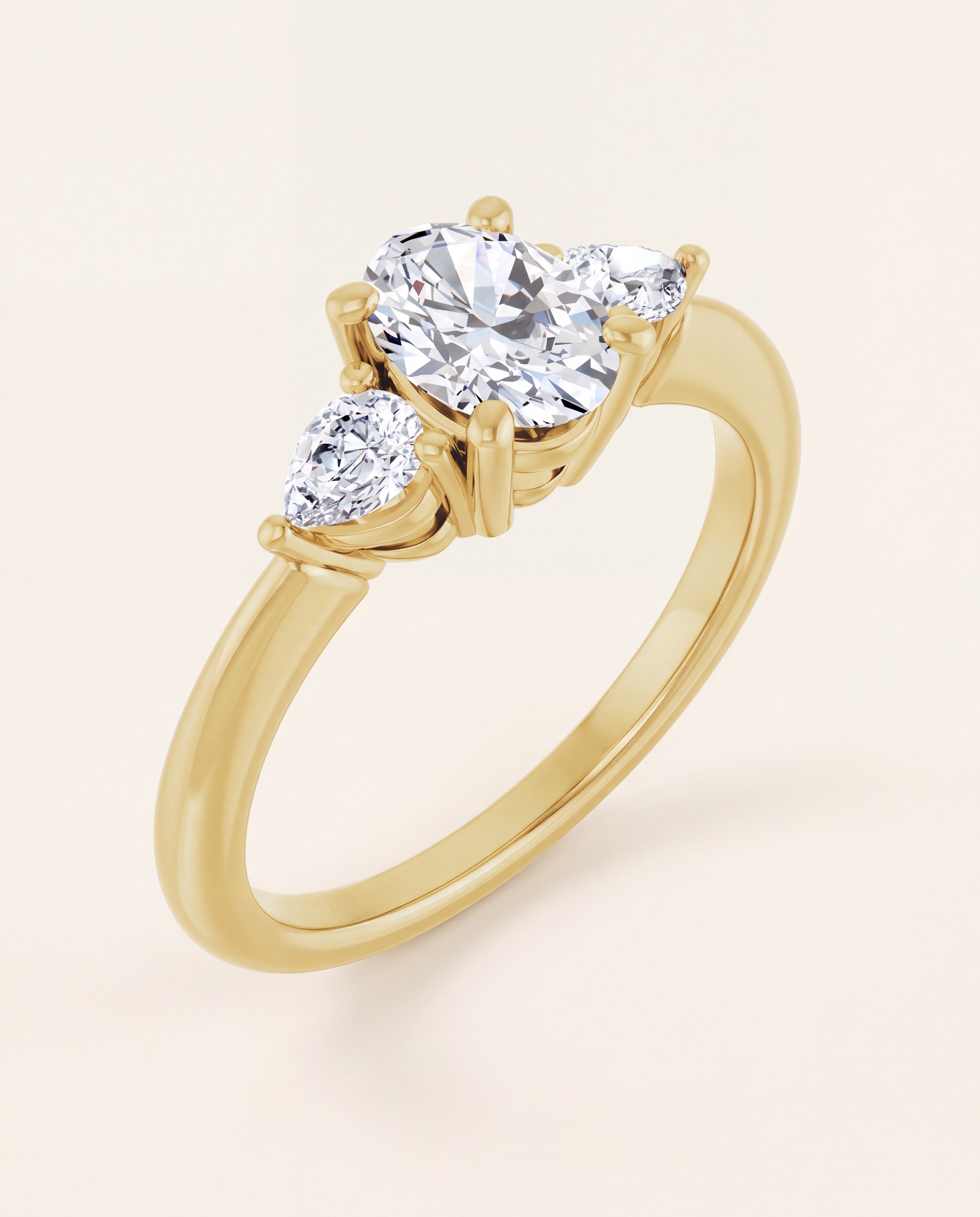 Oval and Pear Three Stone Engagement Ring in yellow gold