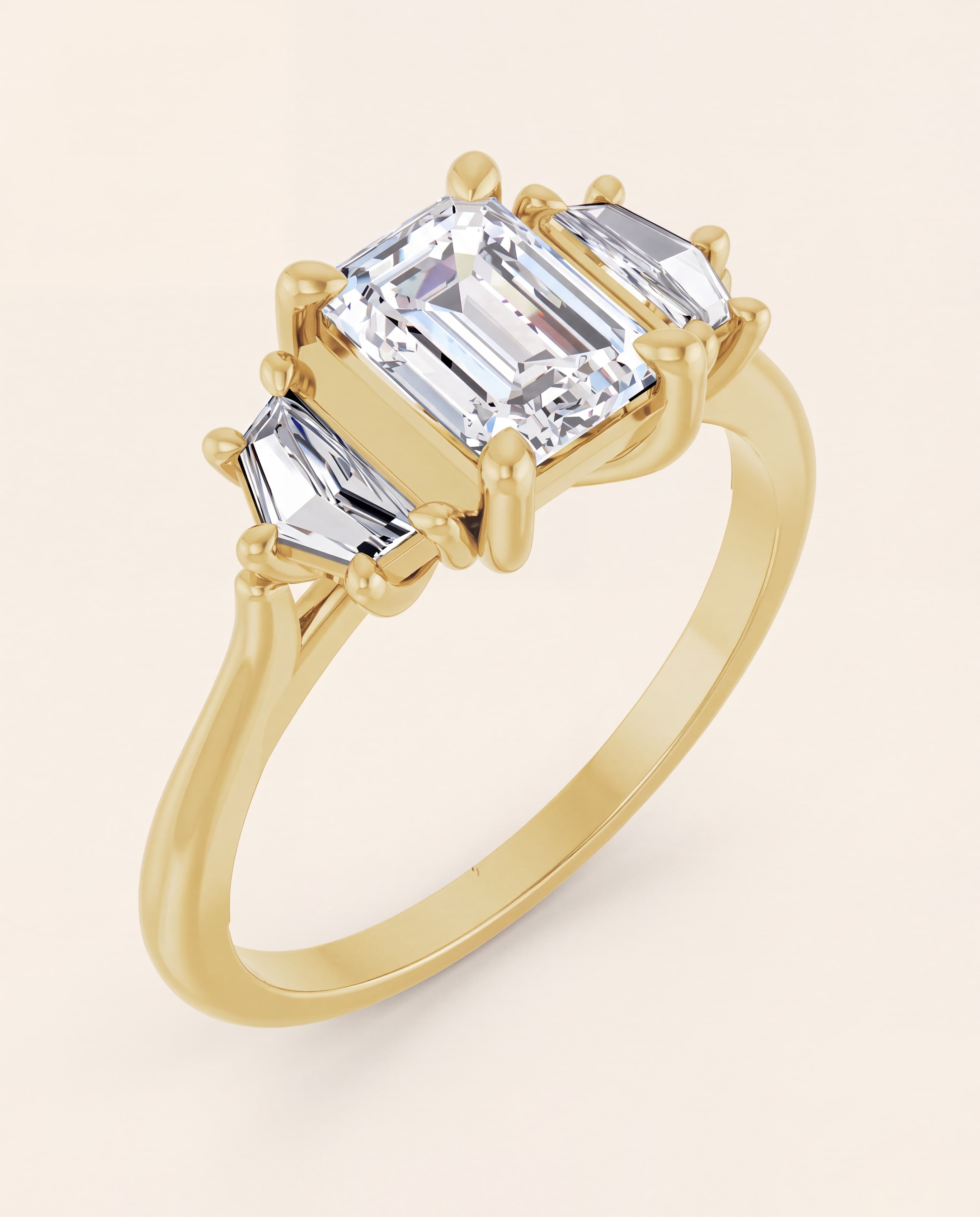Emerald Cut Three Stone Engagement Ring in yellow gold