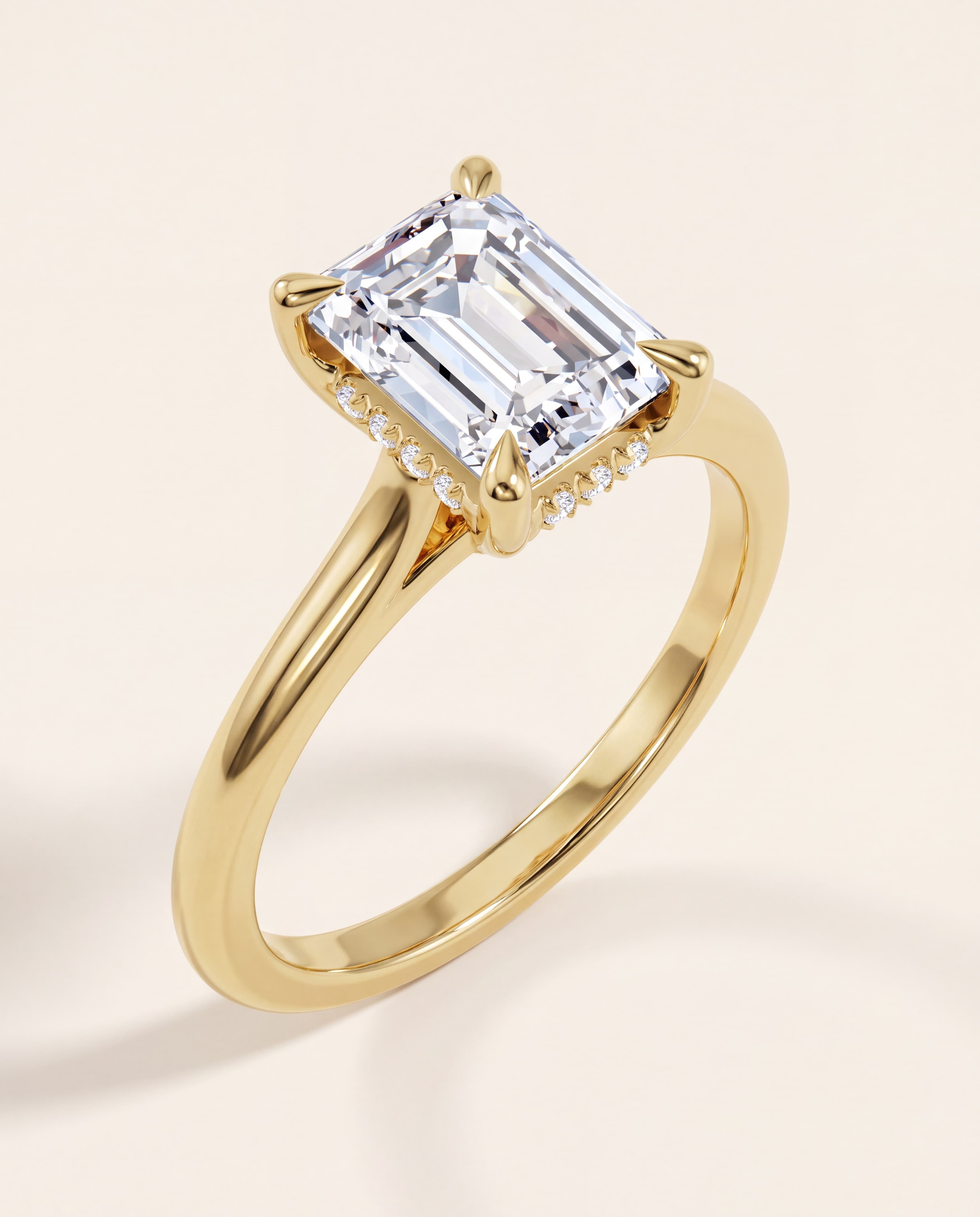 Hidden Halo Emerald Cut Engagement Ring in yellow gold